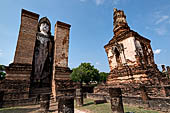 Thailand, Old Sukhothai - Wat Mahathat, on both sides of the main chedi a 12-metre-tall statue of standing Buddha is enshrined in a mandapa. 